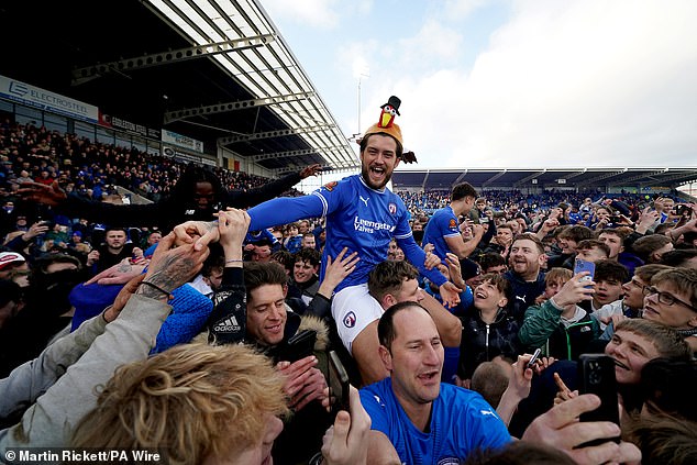 Supporters poured onto the pitch to toast their side's inevitable return from non-league play