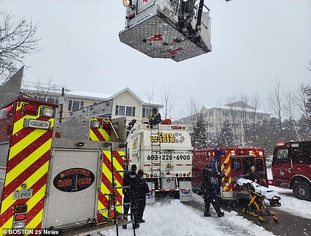 After the woman was rescued from the truck, she was placed on a stretcher and rolled to an ambulance by both paramedics and firefighters as snow showers fell from the sky.