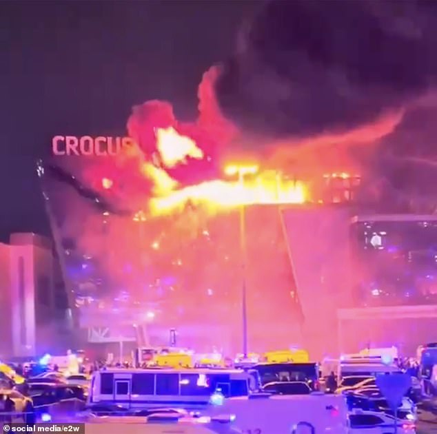 A photo from last night's scene shows the Crocus City Hall concert hall engulfed in flames as the venue is surrounded by emergency services