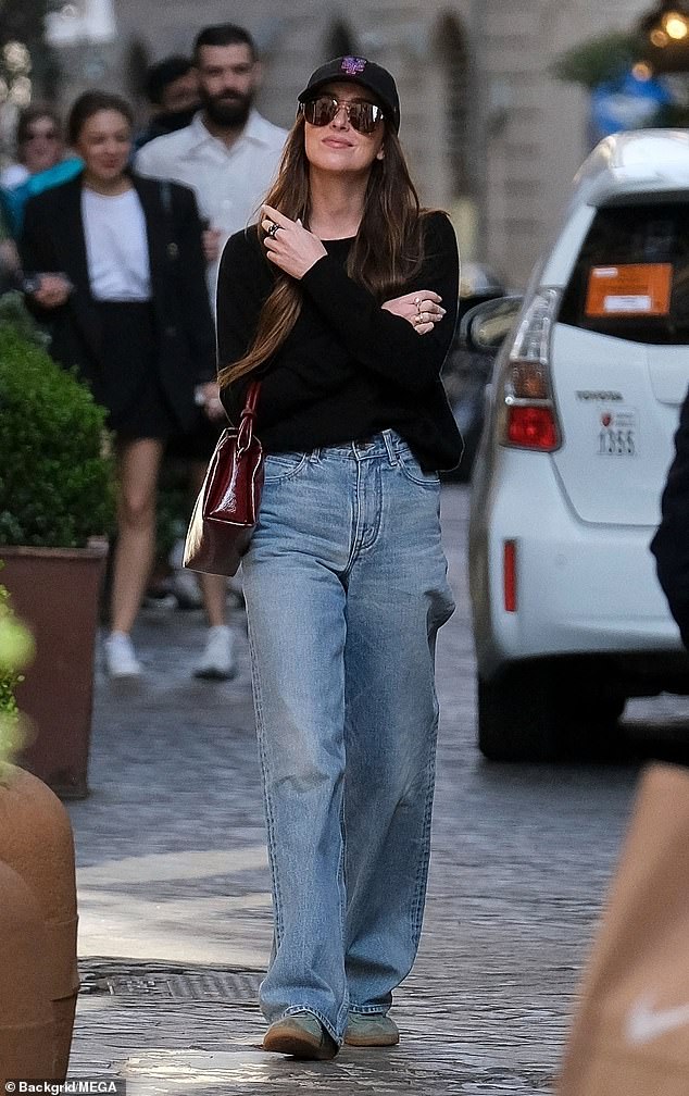 For their day walk through the city, she wore light green sneakers.  She also shielded her eyes with brown aviator sunglasses and a black New York Yankees baseball cap