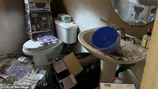 An investigator said he couldn't determine if the house had running water because the sinks and toilets were clogged with so much trash