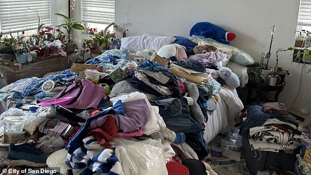 There are piles of clothes laid out in the bedroom at home