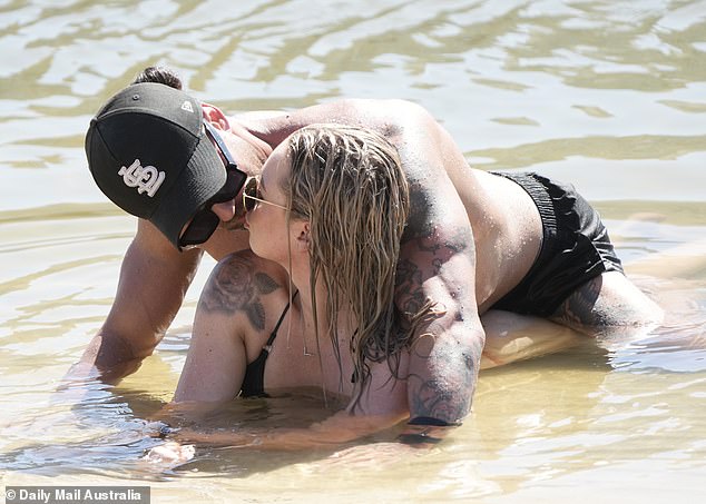 Jack gave Tori a kiss as he lay on top of her as they cooled off along the shore