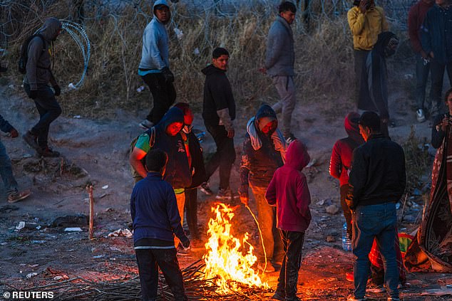 Migrants camp along concertina wire on the U.S. side of the Rio Grande on the day the U.S. 5th Circuit Court of Appeals hears oral arguments on Texas' motion to lift a block on the SB4 immigration law that would allow state officials arrest migrants suspected of being in the country illegally