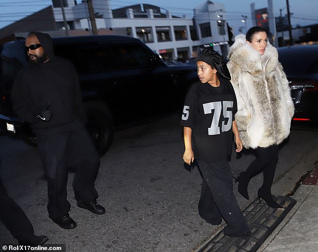 Kanye – who also goes by Ye – wore a black hooded sweatshirt and black wide-leg trousers