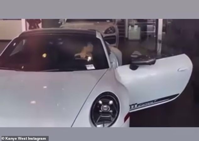 The pair were filmed visiting a car dealership, with Censori sitting in a white Porsche