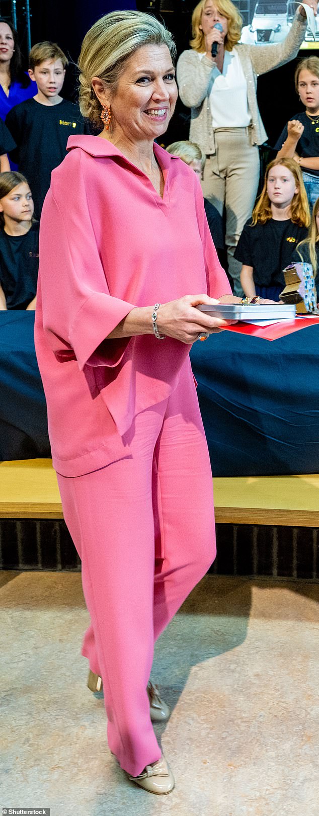 Confident: Queen Maxima of the Netherlands is described as 'confident and comfortable' in the pink ensembles she wears