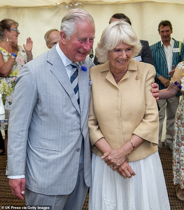 The 75-year-old monarch traveled from London to Windsor Castle on Thursday for a personal conversation with his 'beloved' daughter-in-law.  Pictured with Queen Camilla