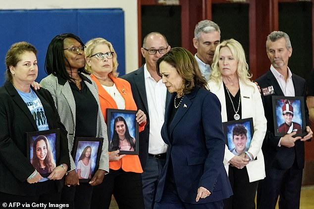 Vice President Kamala Harris walked past grieving parents holding photos of their children to deliver her speech at Marjory Stoneman Douglas High School