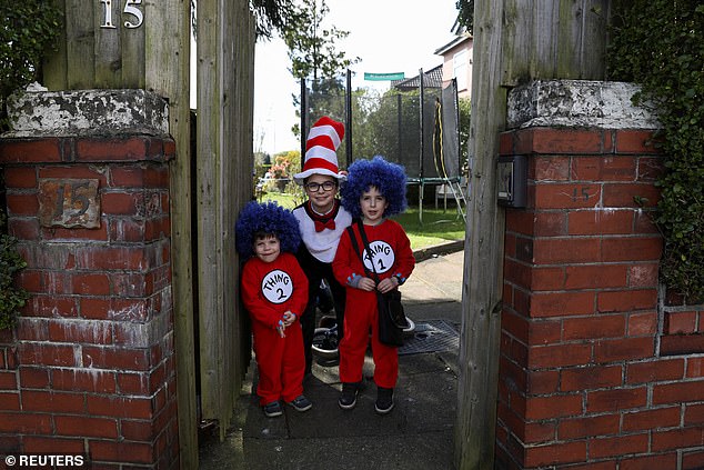 Jewish children dressed in costumes pose for a photo as they celebrate the annual holiday of Purim in Manchester today