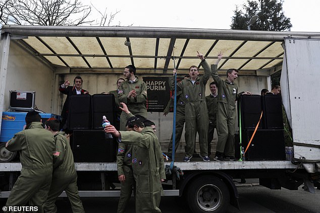 Jewish boys dance and sing on a bus today as they celebrate the annual holiday of Purim in Manchester