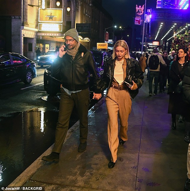 The trendy pair matched in black leather jackets on Sunday, with Bradley chatting on his cell phone as they left the theater