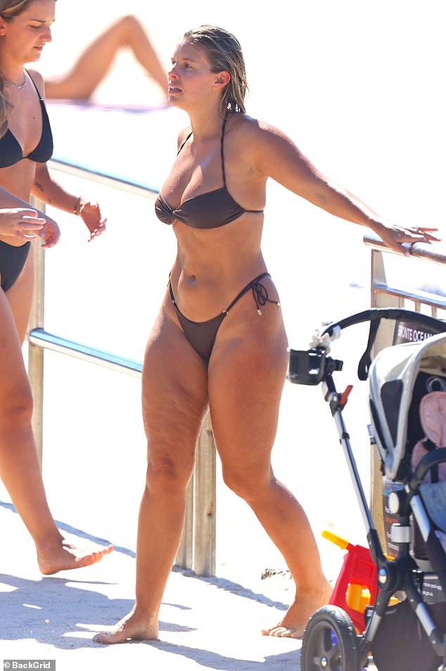 Natasha showed off her ample bust in the swimwear, which included high-cut bottoms