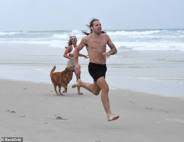 The pair ran around the coast next to the bride's golden retriever, Cub