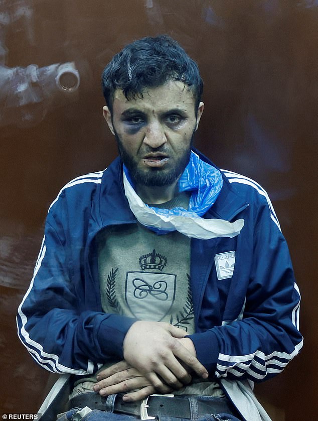 Dalerdzhon Mirzoyev (photo) sits behind a glass wall of a closed room for defendants at the Basmanny District Court in Moscow