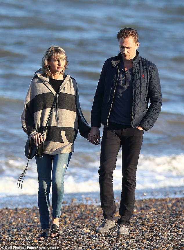 Taylor is seen taking a walk on the beach with her then-boyfriend Tom Hiddleston in 2016