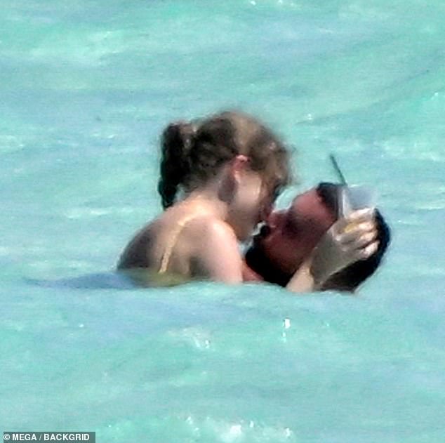 They also couldn't keep their hands - or their lips - off each other, in sizzling PDA