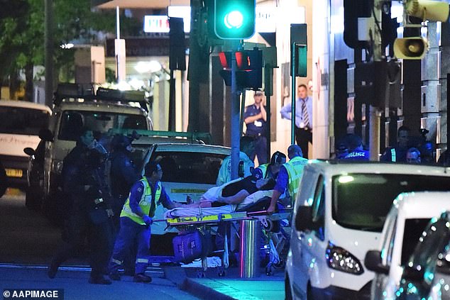 Of the 18 hostages in the cafe, Manis shot dead Tori Johnson, 34, and Katrina Dawson, 38, was killed by police bullet fragments (photo, paramedics working on wounded at end of siege)