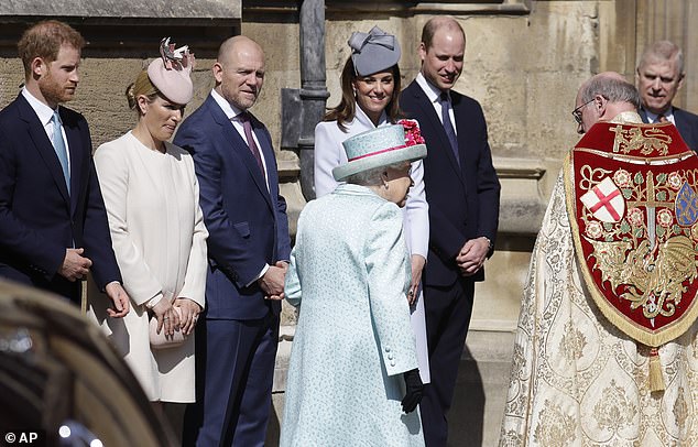 2019 -- Members of the Royal Family, including Prince Harry, Kate and William, watch as Queen Elizabeth II arrives for the Easter Mattins Service at St George's Chapel on April 21, 2019