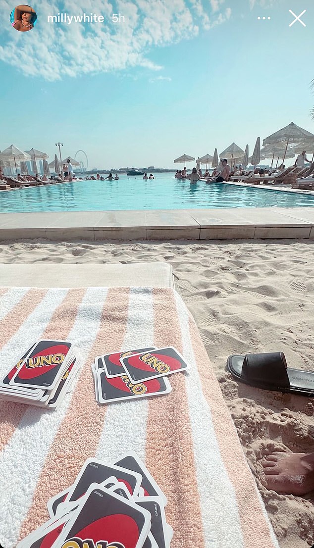 White's wife Milly shared a photo of the pair playing Uno after flying to Dubai on holiday