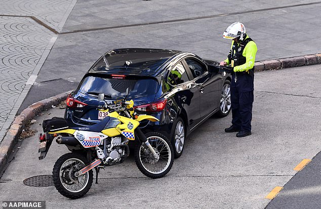 Motorists caught driving under the influence of alcohol and drugs and not wearing a seat belt will also receive double demerit points (in the photo a police officer speaking to a driver)