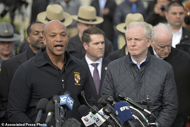 Maryland Governor Wes Moore, left, speaks during a press conference as Senator Chris Van Hollen looks on near the stage