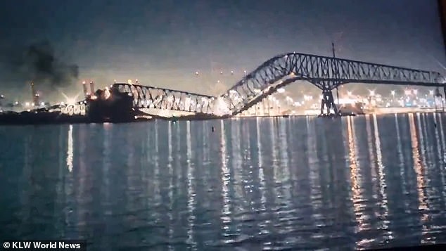 The bridge is seen here collapsing into the Patapsco River in the early hours of Tuesday