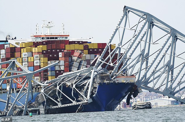 A cargo ship is trapped under part of the structure of the Francis Scott Key Bridge after the ship reaches the bridge