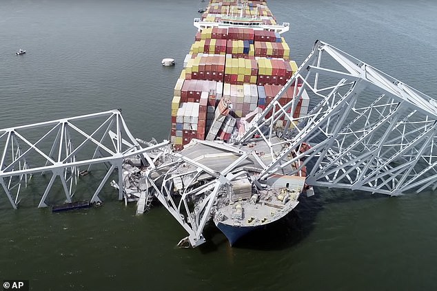 The cargo ship Dali is trapped under part of the structure of the Francis Scott Key Bridge after the ship struck the bridge