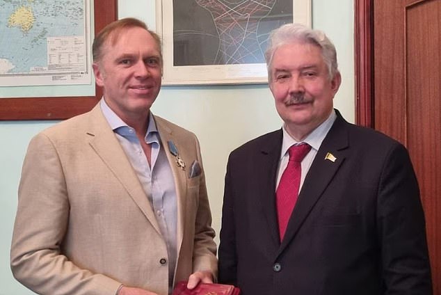 Mr McRae received a badge of honor from Russian opposition candidate Sergey Baburin this month while participating in an election observation program in Moscow