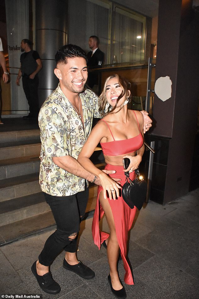 Jade, 26, showed off her cleavage in a skimpy red bra top paired with a matching skirt with a thigh-high slit