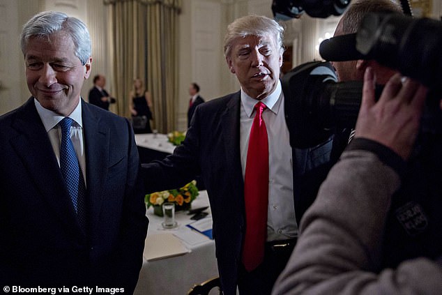 US President Donald Trump stands to the left of Jamie Dimon, CEO of JPMorgan Chase & Co..