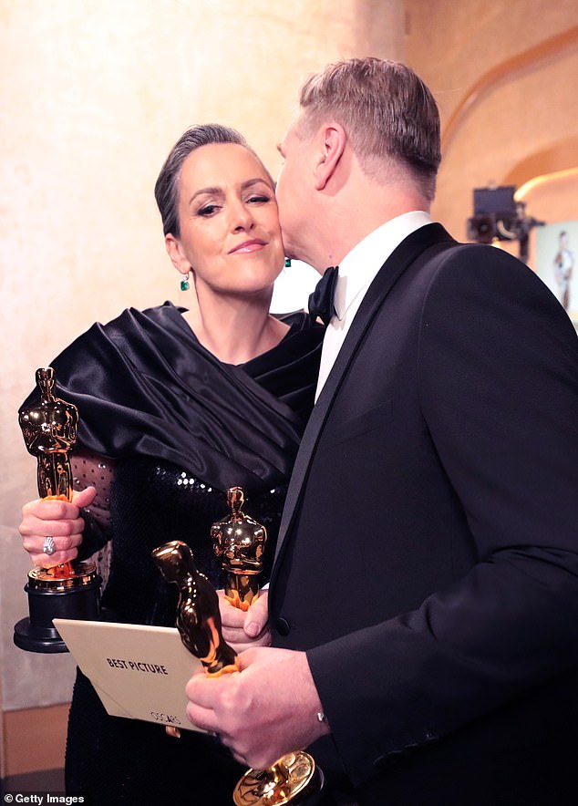 Christopher lovingly kisses his wife's cheek during the 96th Annual Academy Awards at Dolby Theater on March 10, 2024 in Hollywood, California