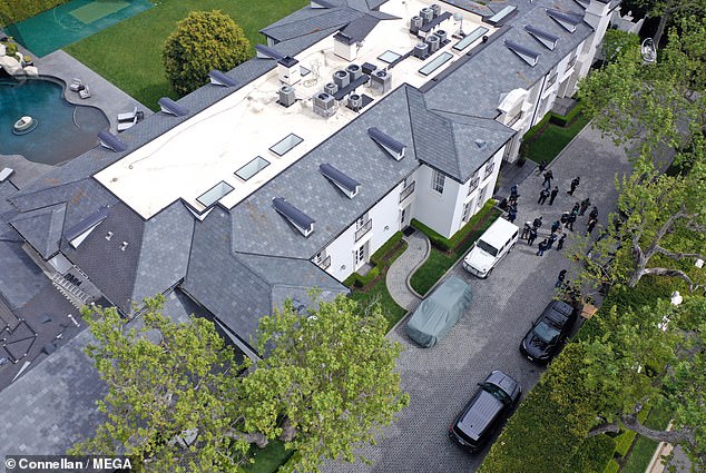 Homeland Security agents are seen outside Diddy's Los Angeles home on Monday as part of an ongoing sex trafficking investigation