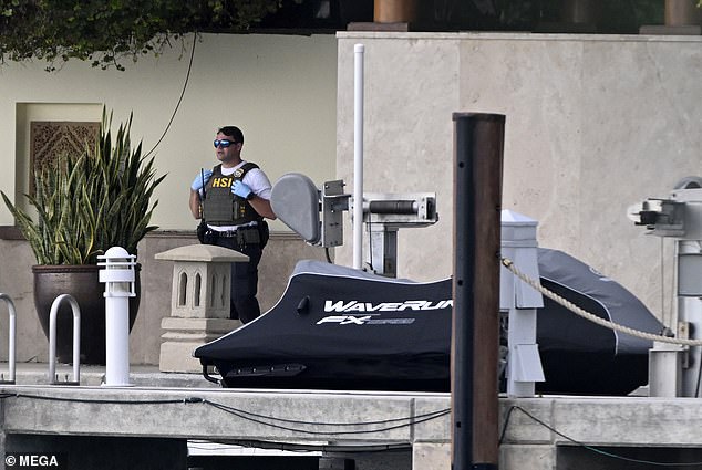 An HSI (Homeland Security Investigations) agent is seen at Diddy's waterfront mansion in Miami on Monday