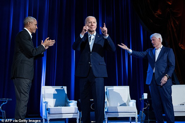 President Joe Biden (center) points his fingers at the audience next to former President Barack Obama (left) and former President Bill Clinton (right).  Lawyer for Lizzo's backup dancers called it 'embarrassing' that she was booked as the president's opening act