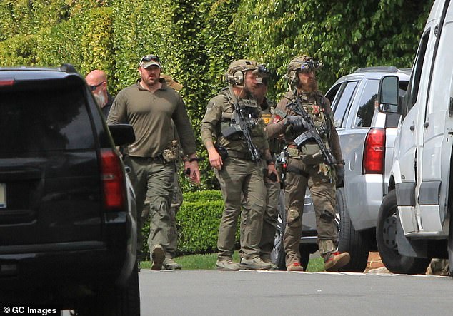 Law enforcement officers are seen outside Diddy's Beverly Hills estate in LA on Monday