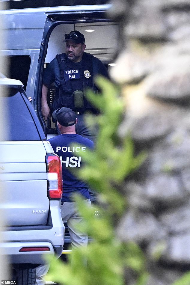 Police and homeland security officers are seen at Diddy's waterfront mansion in Miami on Monday