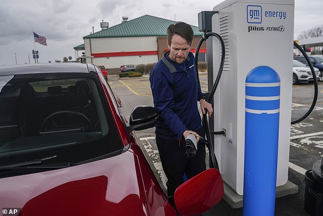 Liam Sawyer of Indianapolis charges his 2023 Ford Mustang Mach-E earlier this month at one of the operational charging stations built with infrastructure bills.  This is located in London, Ohio