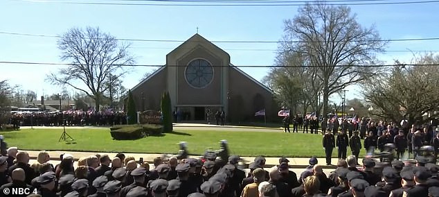 Hundreds of police officers outside St Rose of Lima RC Church in Massapequa, Long Island, as many others line the street that will take the hearse