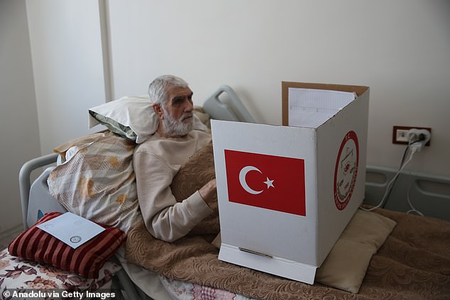 A citizen who was unable to go to the polls due to illness or disability casts his vote for the municipal elections via a mobile ballot box