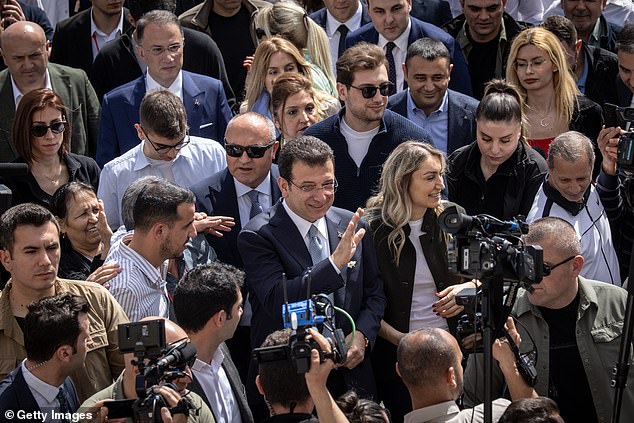 Ekrem Imamoglu, mayor of Istanbul and Republican People's Party candidate for re-election, waves as he arrives to cast his vote