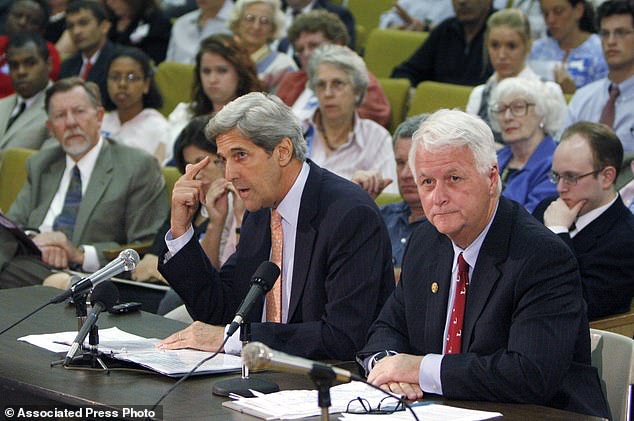 Senator John Kerry, center, speaks with U.S. Representative William Delahunt, right