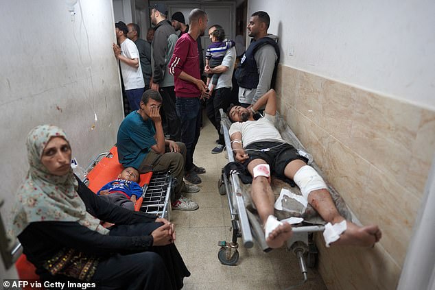 An injured Palestinian man lies on a stretcher in a corridor of the Al-Aqsa Martyrs Hospital in Deir al-Balah in the central Gaza Strip, after the bombing of Israel on March 31.