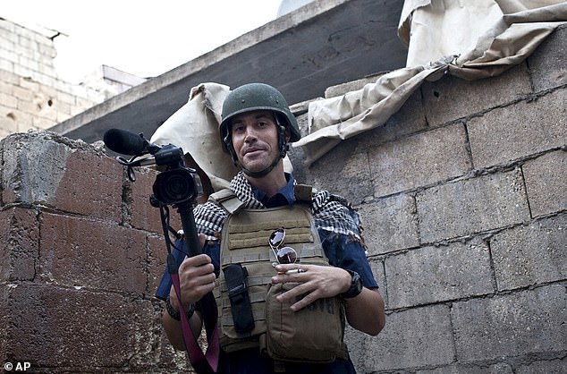 In this November 2012 file photo, journalist James Foley is seen reporting on the civil war in Aleppo, Syria.  Days later he was arrested as he left the country for Turkey