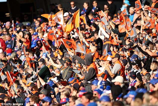 With racism still a big talking point among footy fans, it can now be revealed that the AFL last season issued 16 lifetime bans on 'fans' found to be guilty of racially assaulting players in stadiums across the country (pictured, AFL supporters of the Giants and Bulldogs)