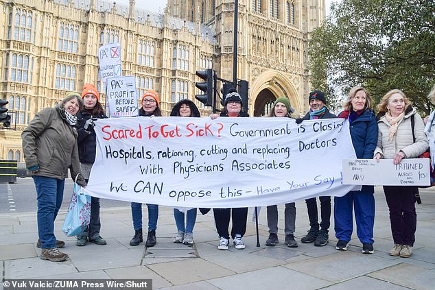 The Mail on Sunday has now discovered that the NHS is rolling out 'apprenticeships' for PAs.  Protesters hold a banner outside the Houses of Parliament