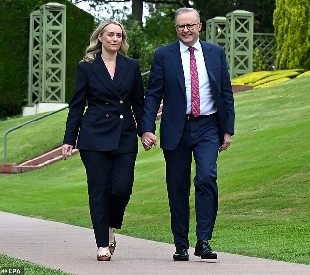 Anthony Albanese (pictured with partner Jodie Haydon) is facing criticism after announcing a $2 billion green energy investment fund for South East Asia as Australia continues to face a crippling cost of living crisis