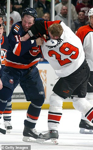 Chris Simon #12 of the New York Islanders and Todd Fedoruk #29 of the Philadelphia Flyers fight during their match on February 27, 2007 at Nassau Coliseum