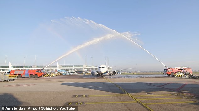 An aviation expert from Amsterdam Schiphol Airport has shed light on an insider tradition known as the 'water cannon salute', in which jets of water create an 'arc' for the plane to pass under